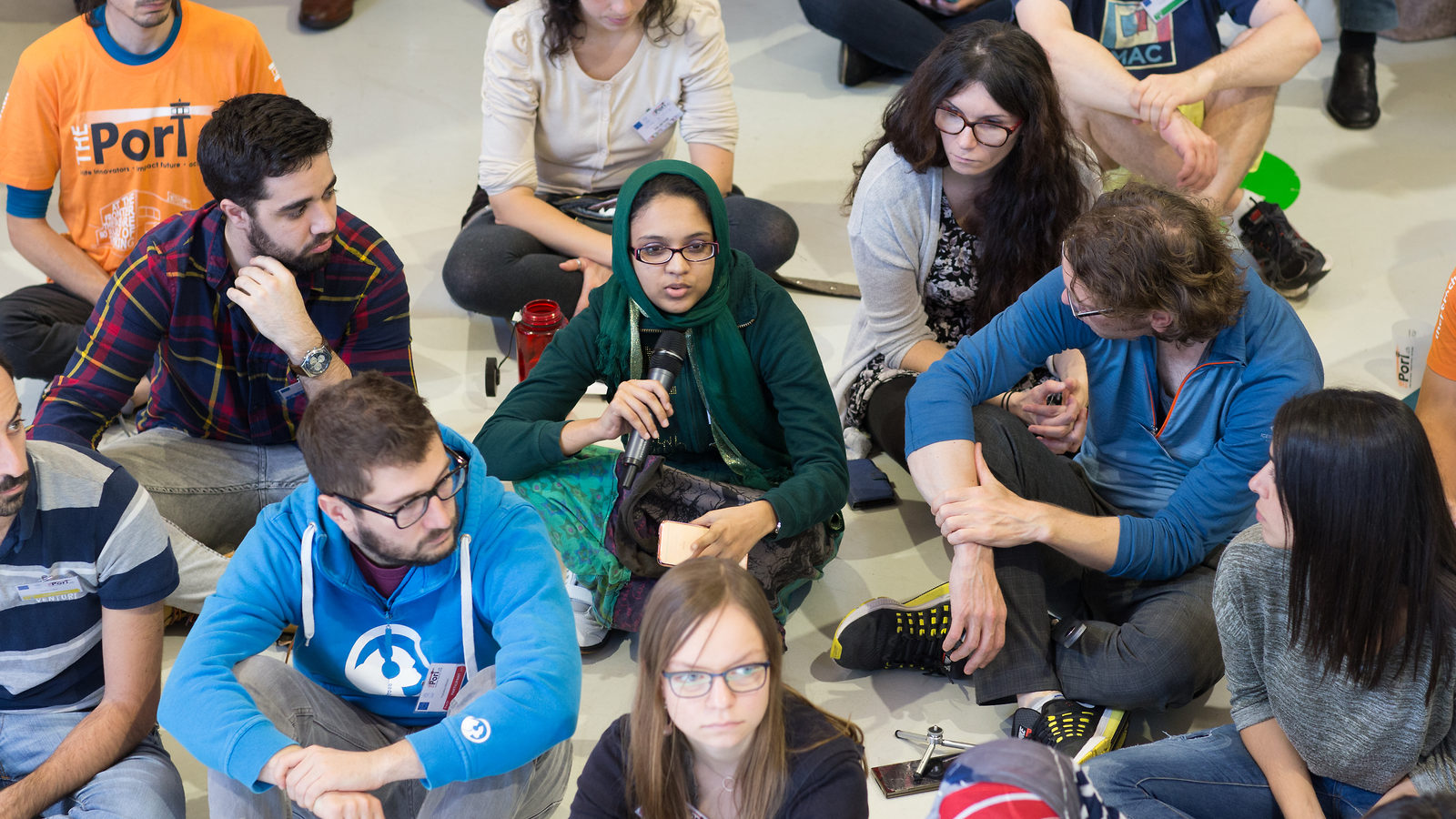 Group of students sitting on the floor talking 